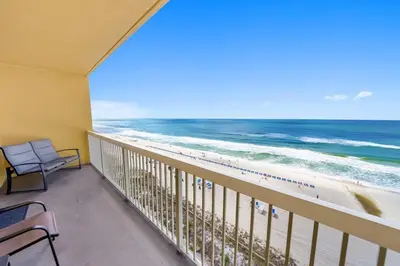 a balcony with a view of the beach at Calypso 908W Stunning condo, beach front, and immaculate in Panama City Beach