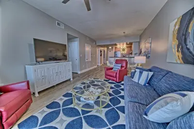 a living room with a couch and a table at Aqua 707 in Panama City Beach