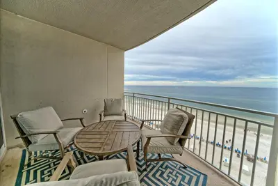 a balcony with a table and chairs and the ocean at Aqua 707 in Panama City Beach