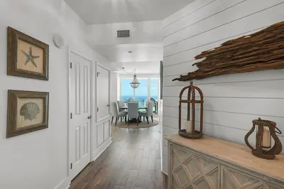 a hallway of a home with a dining room with the ocean at Aqua 901 in Panama City Beach