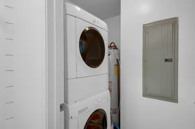 a white washer and dryer in a white room at Aqua 901 in Panama City Beach