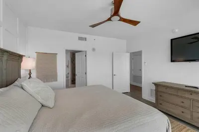 a bedroom with a bed and a ceiling fan at Aqua 901 in Panama City Beach
