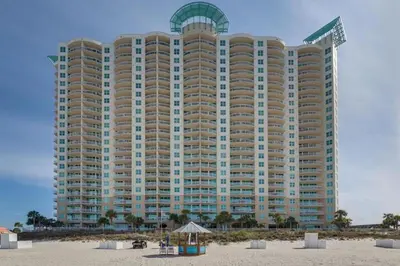 a largeominium building on the beach with a beach at Aqua 901 in Panama City Beach