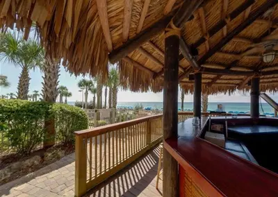 a resort deck with a hot tub on the beach at Calypso 108W Like having your private beach house! Beachfront! in Panama City Beach