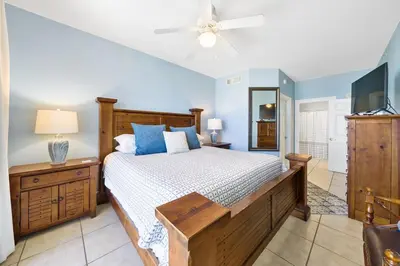 a bedroom with a bed and a ceiling fan at Calypso 108W Like having your private beach house! Beachfront! in Panama City Beach