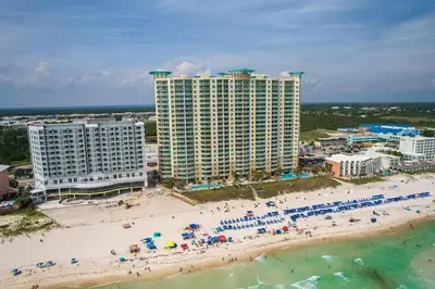 an aerial view of a beach with people and umbrellas at Aqua 1003 in Panama City Beach