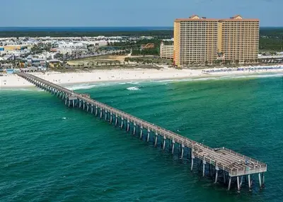 an aerial view of a pier over the ocean with a beach at Calypso 202E Paradise at Calypso 4 chairs daily Gulf Front in Panama City Beach