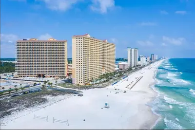 an aerial view of a beach with buildings and the ocean at 1403 Aqua in Panama City Beach