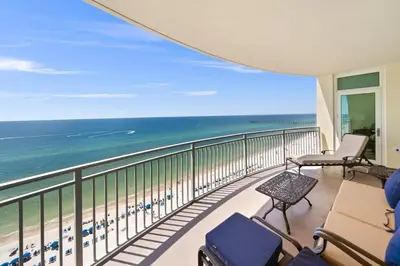 a balcony with chairs and a view of the ocean at 1403 Aqua in Panama City Beach