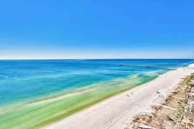 an aerial view of a beach with a pier at Aqua 1710 in Panama City Beach