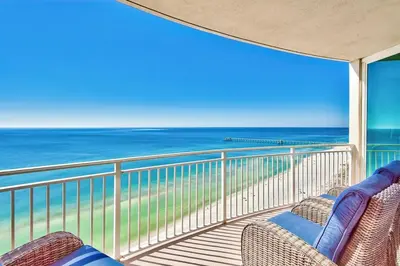 a balcony with two chairs and a view of the ocean at Aqua 1710 in Panama City Beach