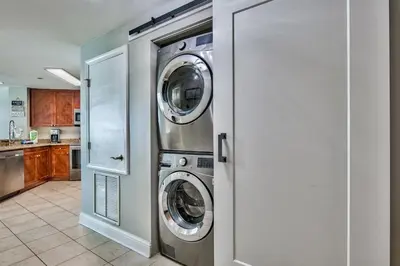 a kitchen with two washing machines in a room at Aqua 1710 in Panama City Beach