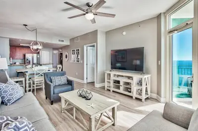 a living room with a couch and a table at Aqua 1710 in Panama City Beach