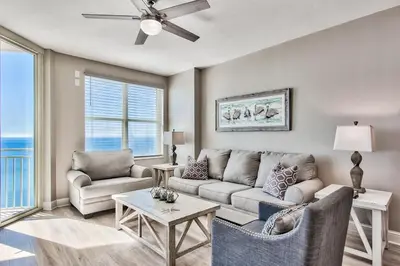 a living room with a couch and a table at Aqua 1710 in Panama City Beach