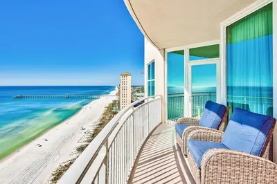 a balcony with chairs and a view of the beach at Aqua 1710 in Panama City Beach