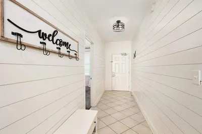 a hallway of a home with a white wall at Aqua 2004 in Panama City Beach