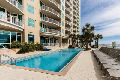 a swimming pool in front of a building at Aqua 2004 in Panama City Beach