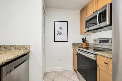 a kitchen with stainless steel appliances and granite counter tops at Aqua 2004 in Panama City Beach