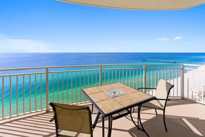 a table and chairs on a balcony with the ocean at Aqua 2008 in Panama City Beach