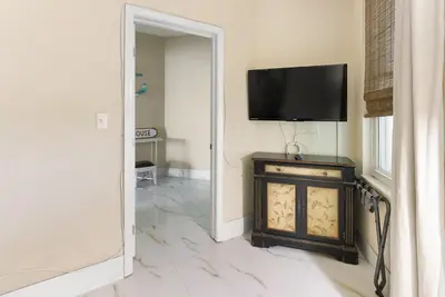 a room with a television on a wall with a fireplace at Aqua 2008 in Panama City Beach