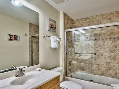 a bathroom with a sink and a shower and a toilet at Aqua 2102 in Panama City Beach