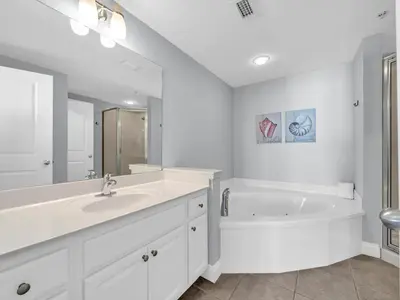 a white bathroom with a tub and a sink at Palazzo 1406 by Emerald Coast Retreats in Panama City Beach