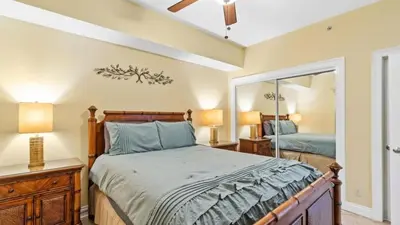 a bedroom with a bed and a mirror at 204 West Calypso 2nd floor Gulf Front Specials! in Panama City Beach
