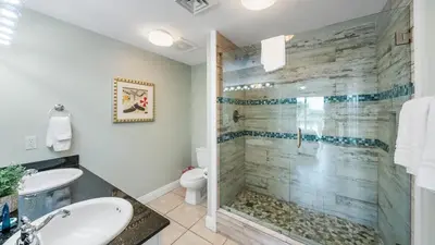 a bathroom with a shower and a sink at Calypso 206W Low Floor West Tower No elevators needed in Panama City Beach