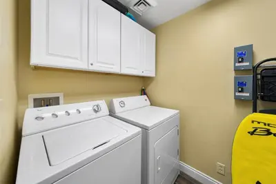 a white washer and dryer in a laundry room at Calypso 209E 2nd floor Corner Unit 2 BR direct beach front in Panama City Beach