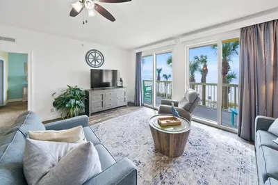 a living room with a couch and a table at Calypso 209E 2nd floor Corner Unit 2 BR direct beach front in Panama City Beach