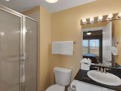 a bathroom with a toilet and a sink and a shower at Calypso 209W Incredible Corner unit Best view in PCB in Panama City Beach