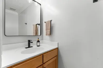 a bathroom with a sink and a mirror at Spring Break! Heated Pool, Walk 2 Beach, Sleeps 11 in Panama City Beach