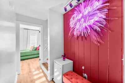 a room with a red wall with a neon sign on it at Spring Break! Heated Pool, Walk 2 Beach, Sleeps 11 in Panama City Beach