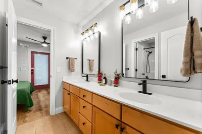 a bathroom with a sink and two mirrors at Spring Break! Heated Pool, Walk 2 Beach, Sleeps 11 in Panama City Beach