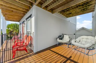 a balcony with two chairs and a table at Spring Break! Heated Pool, Walk 2 Beach, Sleeps 11 in Panama City Beach