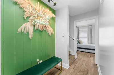 a green wall in a room with a green bench at Spring Break! 2 Homes, 2 Pools, Sleeps 22 in Panama City Beach