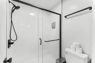 a bathroom with a shower and a toilet at Spring Break! 2 Homes, 2 Pools, Sleeps 22 in Panama City Beach