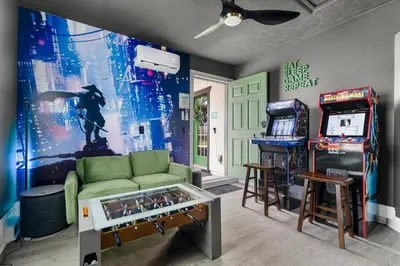 a living room with a room with a video game at Spring Break! 2 Homes, 2 Pools, Sleeps 22 in Panama City Beach