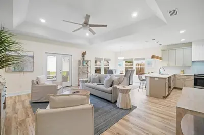 a large living room with a couch and a kitchen at Palm Paradise in Panama City Beach