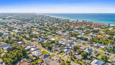 an aerial view of a city with houses and the ocean at Palm Paradise in Panama City Beach
