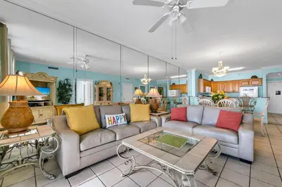 a living room with a couch and a table at Twin Palms 702 in Panama City Beach
