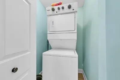 a white washer and dryer in a small bathroom at Twin Palms 702 in Panama City Beach