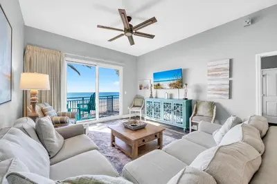 a living room with a couch and a table at Sterling Breeze 205 in Panama City Beach
