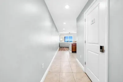 a hallway with white walls and a white door at Sterling Breeze 205 in Panama City Beach