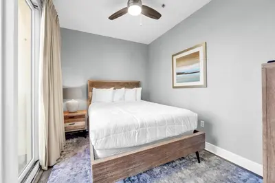 a bedroom with a bed and a ceiling fan at Sterling Breeze 205 in Panama City Beach