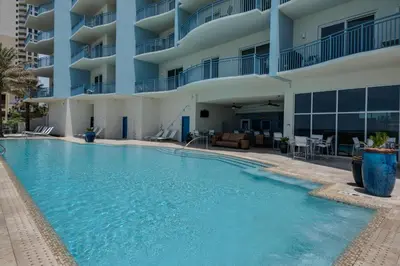 a swimming pool in front of a building at Sterling Breeze 205 in Panama City Beach