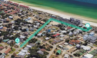 an aerial view of a city with houses and the ocean at A Wave We Go in Panama City Beach