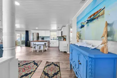 a kitchen with a blue cabinet in a room at A Wave We Go in Panama City Beach