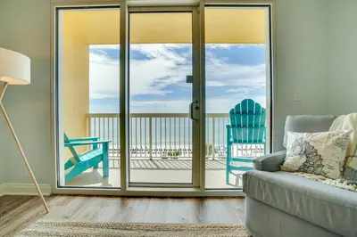 a living room with a couch and a view of the ocean at 408E Calypso Elegant beach front Beach Svc Included in Panama City Beach