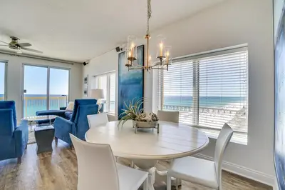 a dining room with a table and chairs at Calypso 909 West Tower GULF FRONT 3BR 3BA Views Forever in Panama City Beach